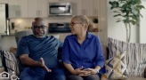 Couple sitting in a well lit living room